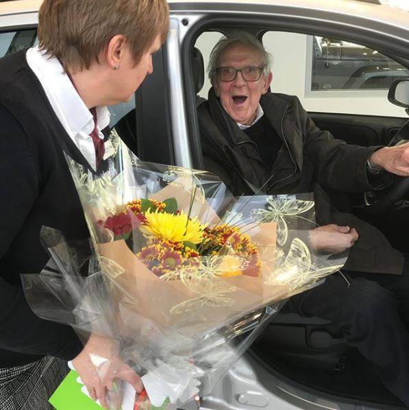 Old gentleman very happy taking delivery of his new car